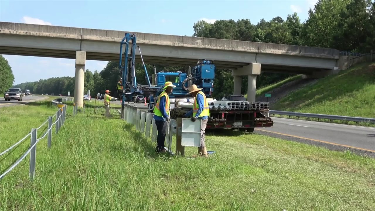 SPIG Industry crew installing guardrail and the SGET End Terminal along a highway